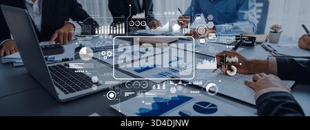 A professional business meeting showcasing a diverse group of people analyzing data with graphs and charts, enhancing strategic decision-making Stock Photo