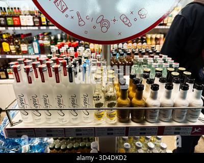 Nowy Dwor Mazowiecki, Poland - October 22, 2025: Colorful bottled beverages lined up on an airport shop shelf near travelers and departures in Nowy Dw Stock Photo