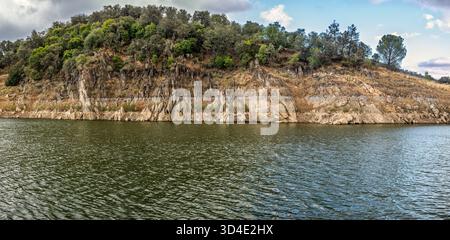 Geological layers at Puente Nuevo Reservoir in Villaviciosa de Córdoba showcase the region's unique tectonic history shaped by time. Stock Photo