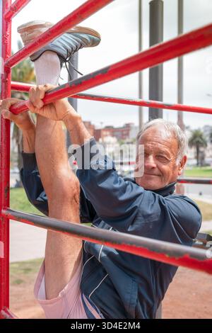Active senior man stretching legs on workout Stock Photo