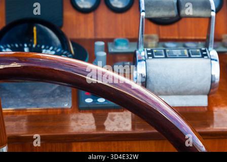 Motor yacht control panel. Steering wheel, gear levers, gauges, speedometers and control buttons Stock Photo