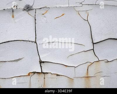Cracked texture of white paint on rusty metal with mold. Texture of old paint. Stock Photo