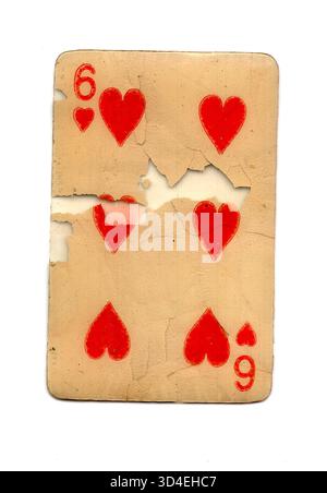 A badly damaged vintage playing card in the suit of hearts isolated on ...