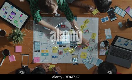 A vibrant workspace showcasing a collaborative brainstorming session on application design, emphasizing user experience and innovative technology Stock Photo