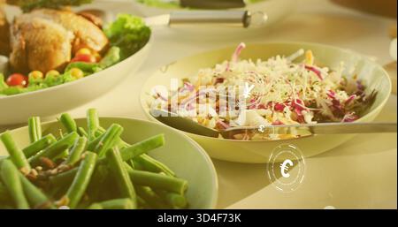 Displaying pale green salad bowl holding slaw on dining table, spoon resting, yen euro overlays Stock Photo