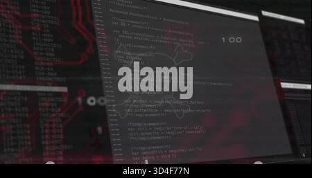 Displaying vertical monitor showing source code with skull overlay at dark workstation, red PCB 100 Stock Photo