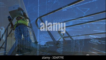 Checking tech using phone-tablet on raised deck, wearing hi-vis vest, with code overlay, copy space Stock Photo