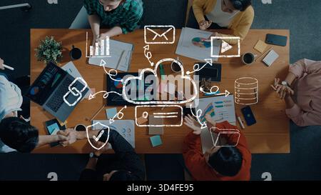 A diverse team collaborates in a modern office setting, surrounded by technology, charts, and documents, showcasing a focus on data analysis and Stock Photo