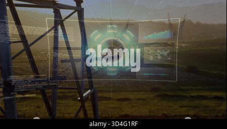 Floating clear hologram interface showing circular hub over fields at dusk, with tower and panels Stock Photo