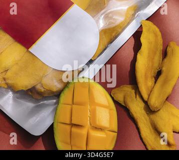 Food, Pack of dried mango slices and raw mango Stock Photo