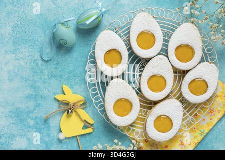 Food, Easter linzer egg cookies with lemon jam filling. Blue background, top view Stock Photo
