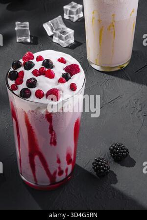 Food, Delicious milkshakes on black stone with ice cubes Stock Photo
