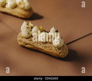Food, Eclairs with whipped cream and hazelnuts Stock Photo