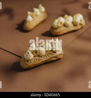 Food, Eclairs with whipped cream and hazelnuts Stock Photo