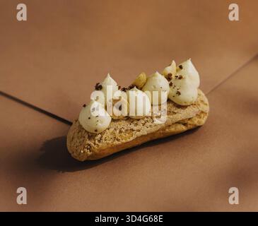 Food, Eclair with whipped cream and hazelnuts Stock Photo