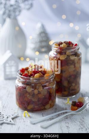 Food, Soaking dried fruits in alcohol, preparing for baking christmas fruit cake or pudding Stock Photo