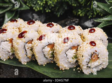 Food, Set of fresh sushi rolls with salmon, avocado and sesame seeds Stock Photo