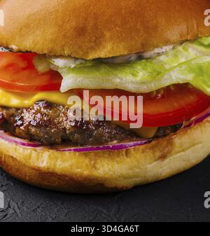 Food, Appetizing cheeseburger on black stone closeup Stock Photo