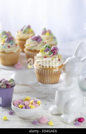 Food, Beautiful festive Easter cupcakes decorated with colorful sprinkles end candy eggs. Happy Easter and spring holiday concept Stock Photo