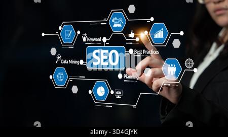 A business professional engages with digital graphics, showcasing strategies for SEO and data mining. This image highlights modern marketing Stock Photo