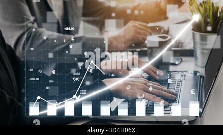 A dynamic scene of business professionals engaged in financial analysis with a digital graph overlay. The image represents growth, collaboration, and Stock Photo