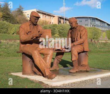 Metal sculpture by Ray Lonsdale of two shipyard workers having a break at St Peters quayside, Sunderland, England, UK Stock Photo