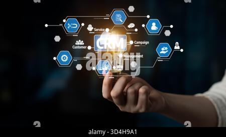 A conceptual image illustrating customer relationship management through a hand holding a lightbulb with digital icons. Represents innovation and Stock Photo