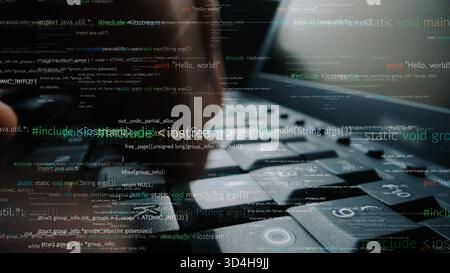 Close-up of hands typing on a laptop keyboard surrounded by abstract digital code, capturing the essence of programming and technology in a modern Stock Photo