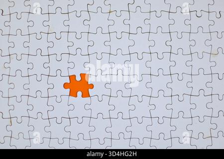 Missing puzzle piece highlights incompleteness, emphasizing how one small part can impact the integrity of an entire system. Stock Photo