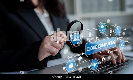 Professional woman examines cloud computing graphics with a magnifying glass, highlighting data privacy, security, and big data in a modern office Stock Photo
