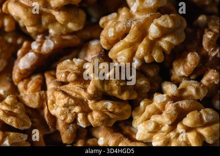 Macro shot of Georgian walnut kernels 50 halves, 50 whole tightly packed on light gray background. Warm autumn tones, oily shine, and natural folds cr Stock Photo