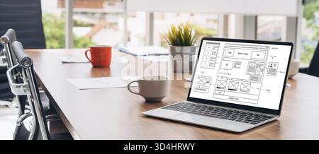 Laptop computer with opened lid on table in meeting room of office workspace. Stock Photo