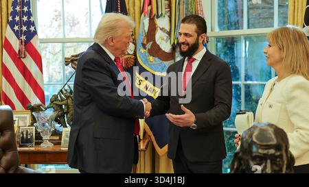 Washington DC, USA. 10 Nov, 2025. Syria's President Ahmed al-Sharaa (C) meets with US President Donald Trump at the White House in Washington, DC, on Monday, November 10, 202. Syrian President Ahmed al-Sharaa held an unprecedented meeting with U.S. President Donald Trump at the White House, just days after Washington removed his name from its terrorism blacklist. Al-Sharaa whose rebel forces toppled longtime ruler Bashar al-Assad late last year, became the first Syrian leader to visit the White House since the country's independence in 1946. Photo by Syrian Presidency/UPI. Stock Photo