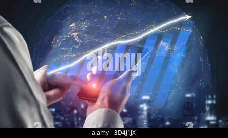 A business professional interacts with a smartphone displaying financial data trends and growth graphs while in a modern office environment. Copula Stock Photo