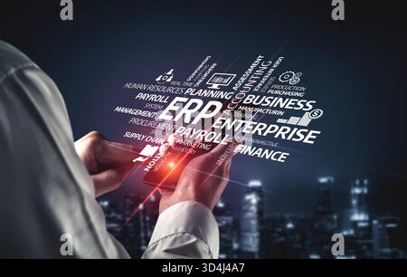 A person interacts with a smartphone showcasing ERP solutions in a modern digital landscape. The image emphasizes business management concepts and Stock Photo