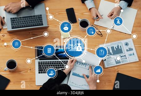 A diverse team collaborates on tax strategy using laptops and documents, emphasizing teamwork and financial analysis at a modern workspace. Amity Stock Photo