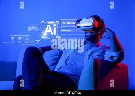 A cheerful man experiences virtual reality with an AI chatbot, set in a modern living room. The vibrant blue tone enhances the futuristic atmosphere Stock Photo