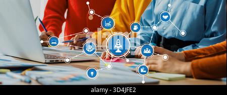 A diverse team collaborates around a laptop, utilizing data visualization graphics to enhance business strategy and innovation in a modern workspace Stock Photo