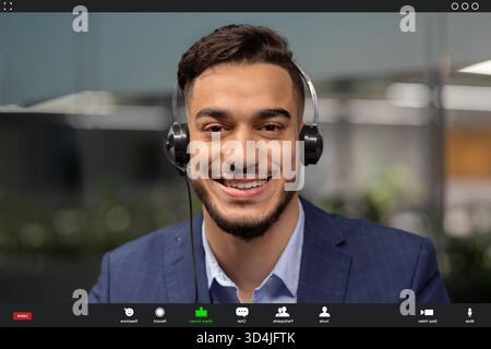 Video Chat With a Smiling Middle Eastern Businessman Using Headset for Remote Communication Stock Photo