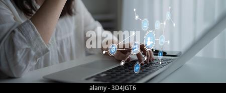 A young woman is engaged with her laptop, as digital social media icons emerge, representing the essence of online networking and communication in Stock Photo
