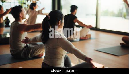 People, fitness and stretching with yoga class for spiritual wellness, mindfulness or training. Session, group or yogi with coach or trainer for Stock Photo