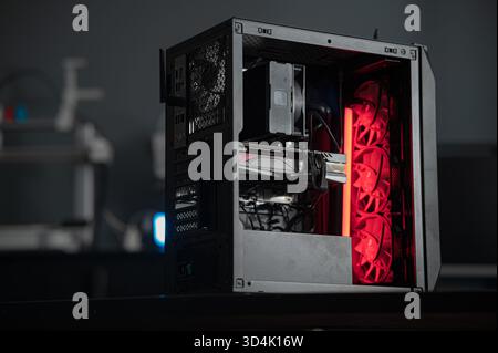a black computer case without side walls on a blurred background. disassembled computer case Stock Photo