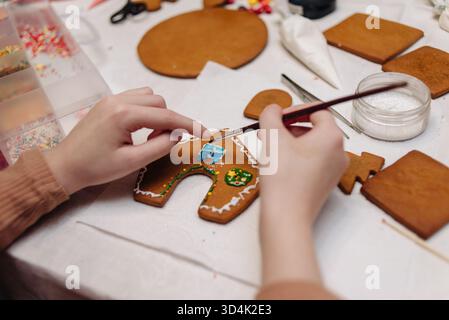 kids making gingerbread men and gingerbread house during the holidays. High quality photo Stock Photo