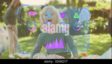 Laughing child wearing green top and tulle playing in sunlit backyard with AR HUD and bubbles Stock Photo
