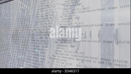 Displaying translucent monitor showing network logs in office, with IPs and city reflections Stock Photo