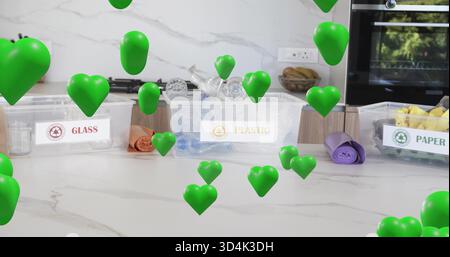 Showing plastic bin labeled PLASTIC with bottles and caps on marble counter, floating green hearts Stock Photo