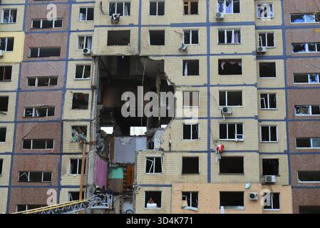 A Russian missile strike destroyed a house in Dnipro, Ukraine. A large hole in the residential building after a drone strike and fire. Russia's war ag Stock Photo