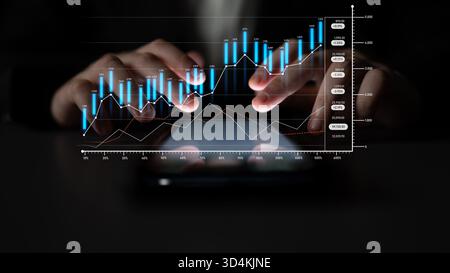 Close-up view of hands interacting with a tablet displaying financial graphs and charts, highlighting business growth, investment opportunities, and Stock Photo