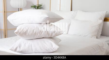Stack of soft pillows on bed Stock Photo