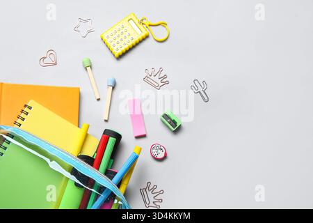 Pencil case with different school stationery on light background Stock Photo